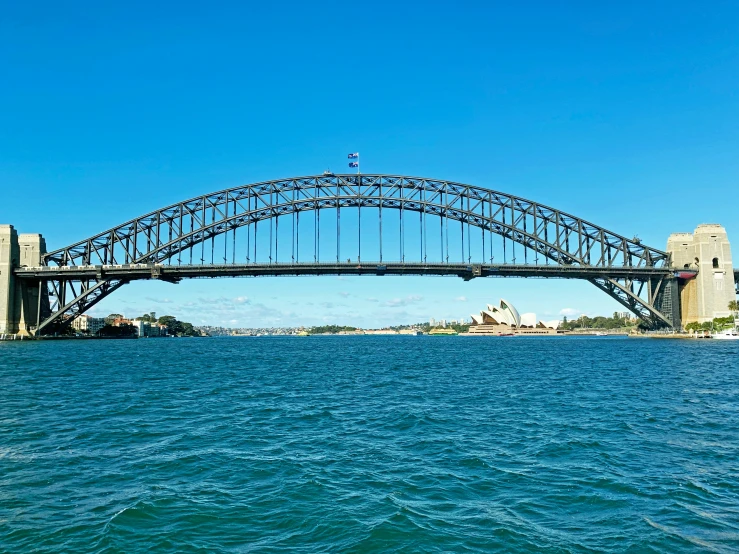 sydney harbour in front of a bridge and the sydney opera