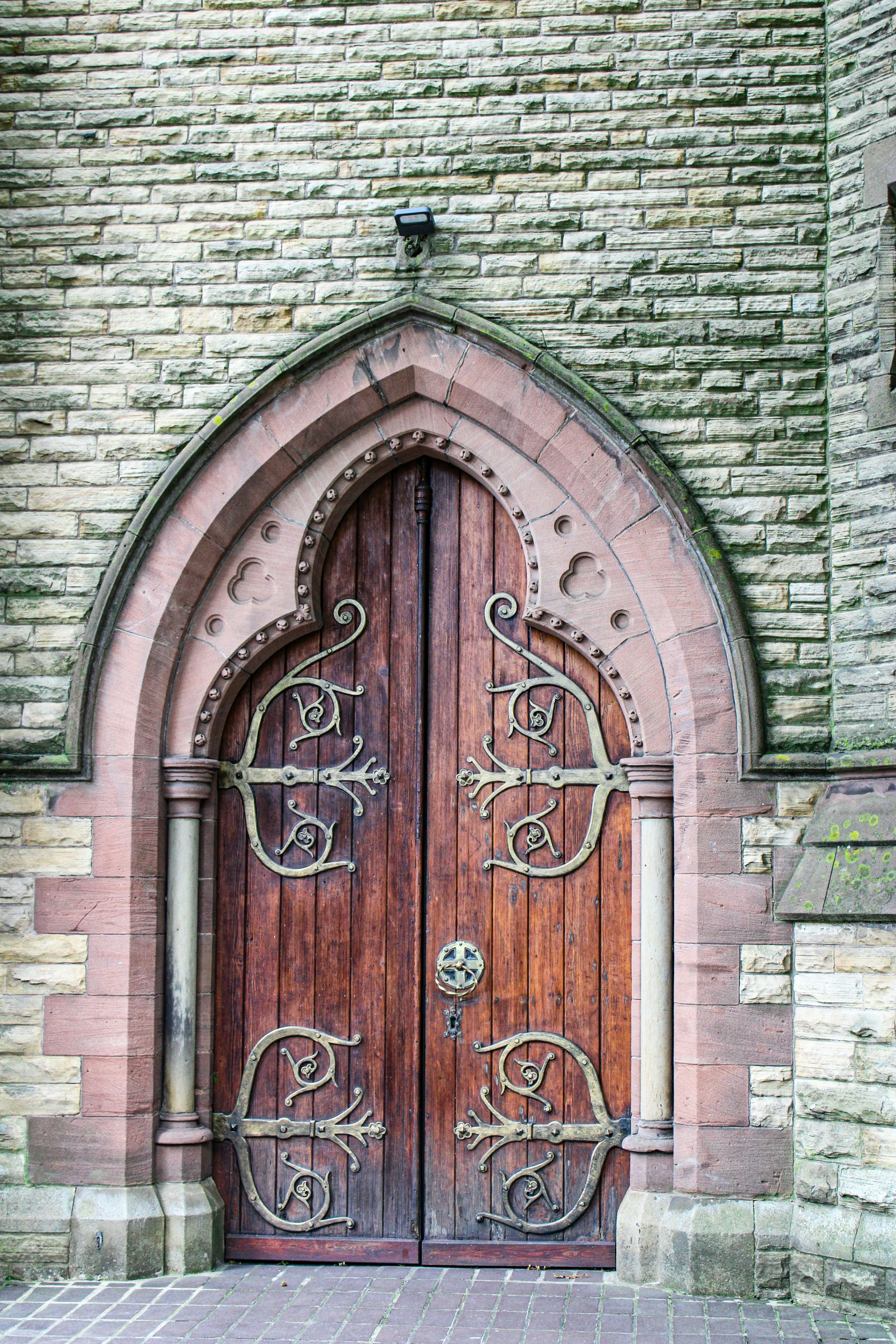 an old brick building with two wooden doors