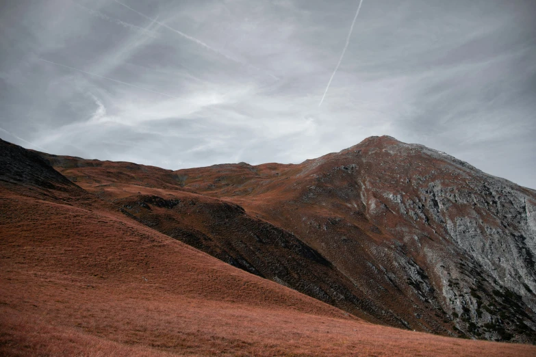 a couple of mountain peaks on a cloudy day