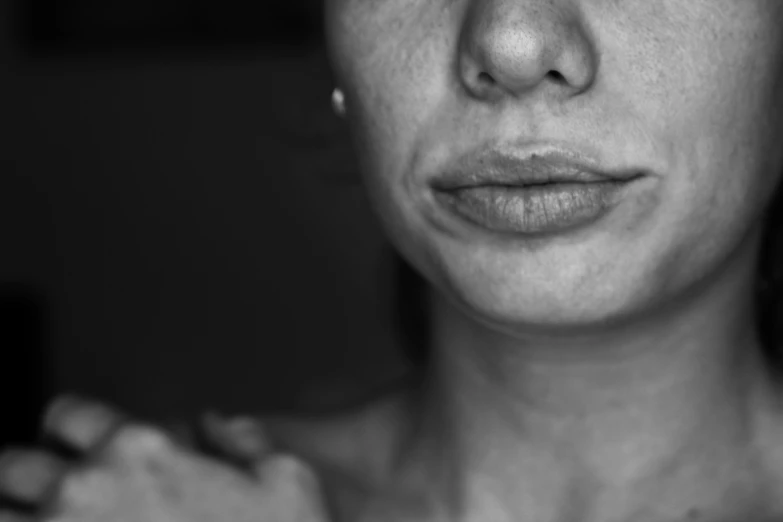 a black and white po of a woman's face and nose