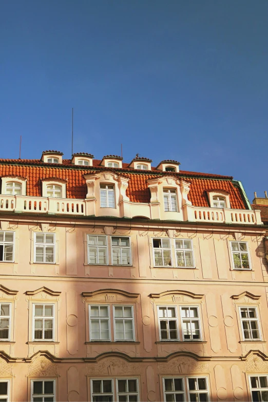 an old building with many windows and a red roof