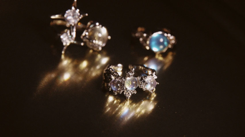 three pairs of earrings sit side by side on a table