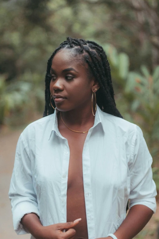 young black woman in white shirt with her hands clasped