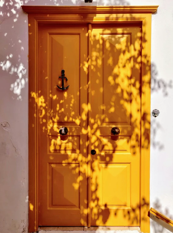 the front door of a building with a yellow painted door