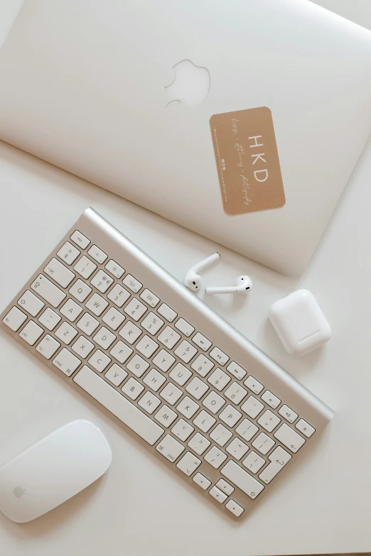 a white keyboard sitting next to a laptop computer