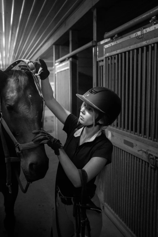 there is a woman holding the bridle on a horse