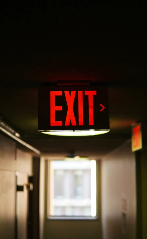 an exit sign lit up in the dark