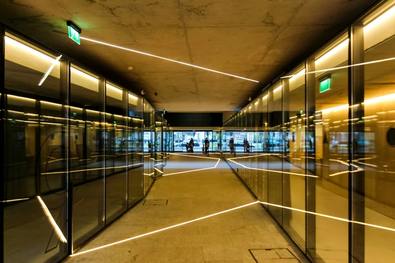 an empty hallway with many glass doors