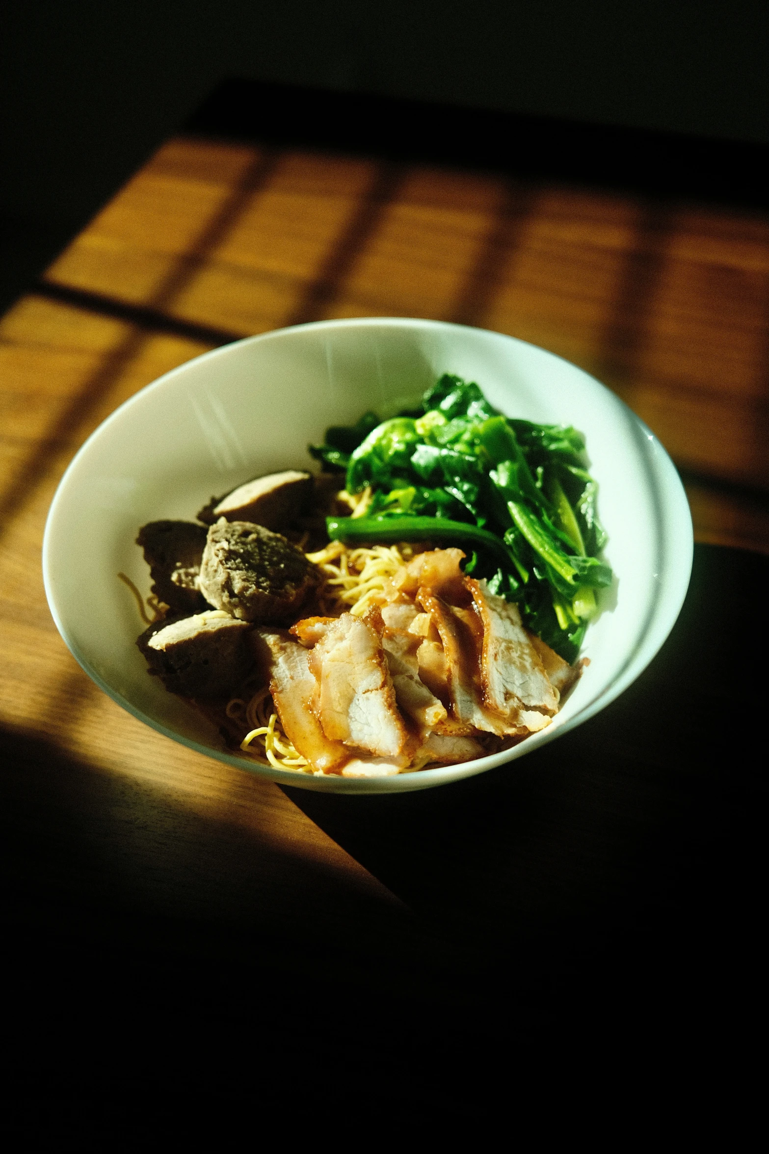 a bowl of food with meat and some broccoli