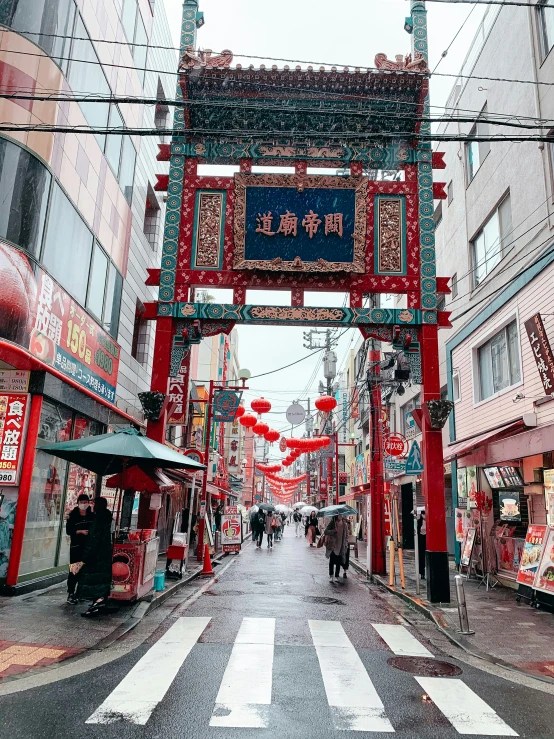 a chinese gate on the side of a road