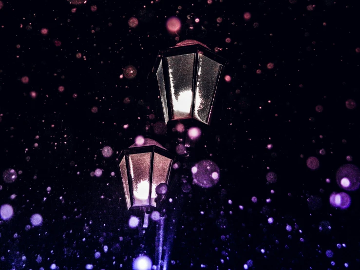 a street lamp on the sidewalk during a snow storm