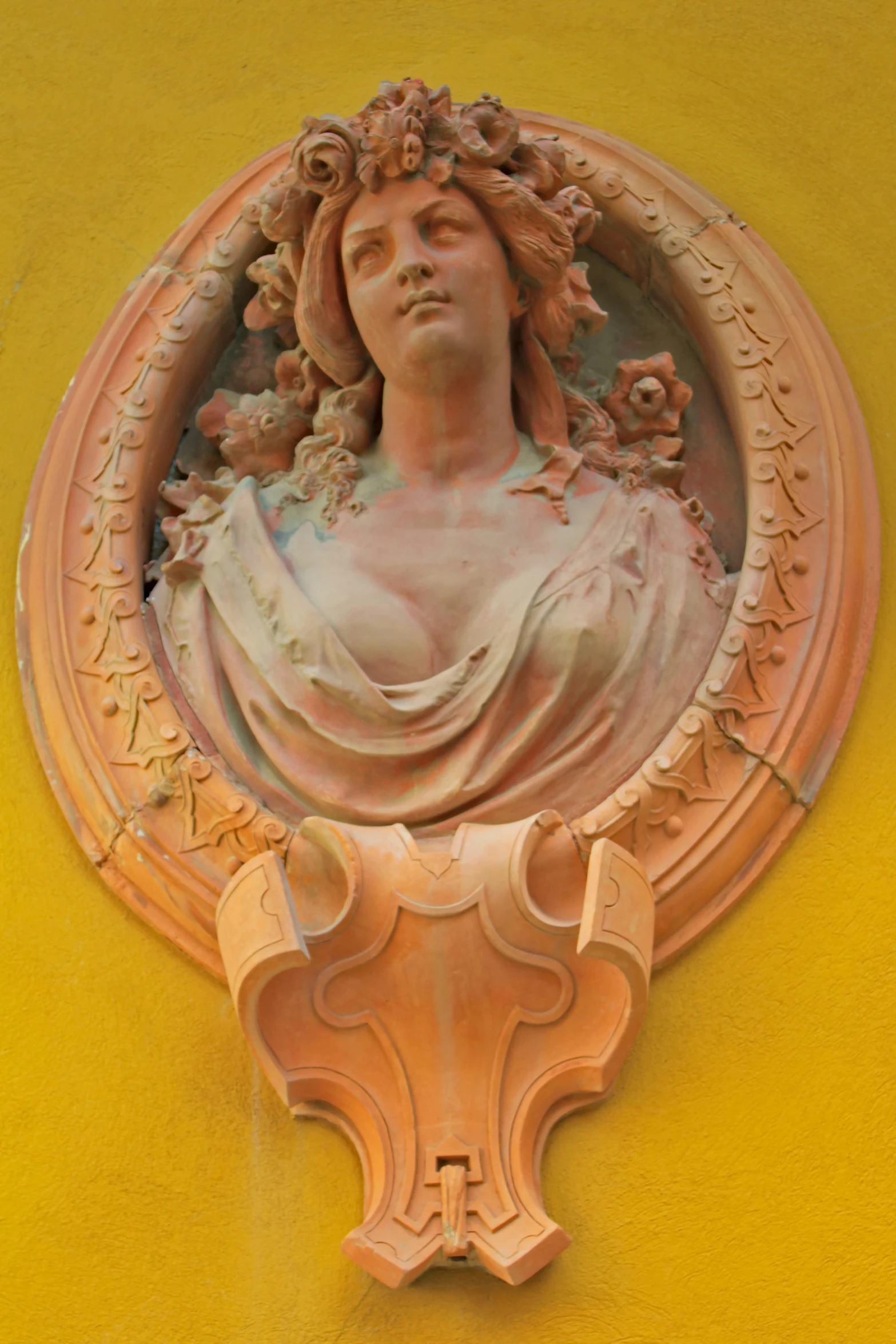 a close - up view of a sculpture on a yellow wall