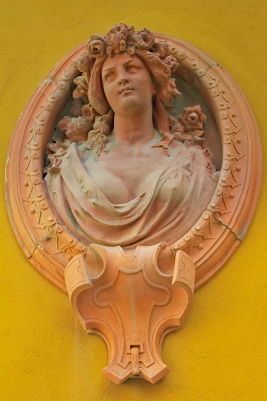 a close - up view of a sculpture on a yellow wall