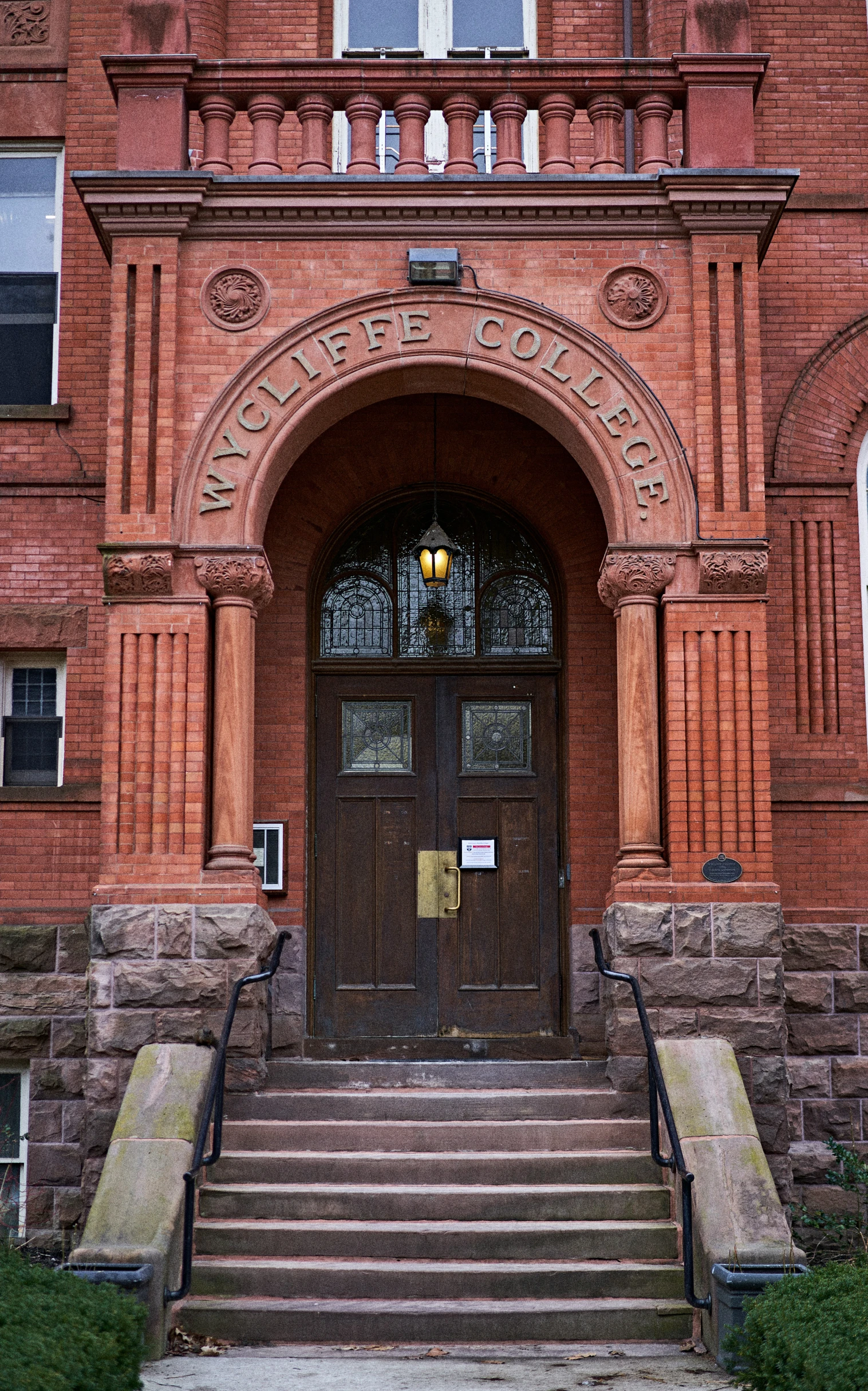 a large building with arched doorway and steps to it