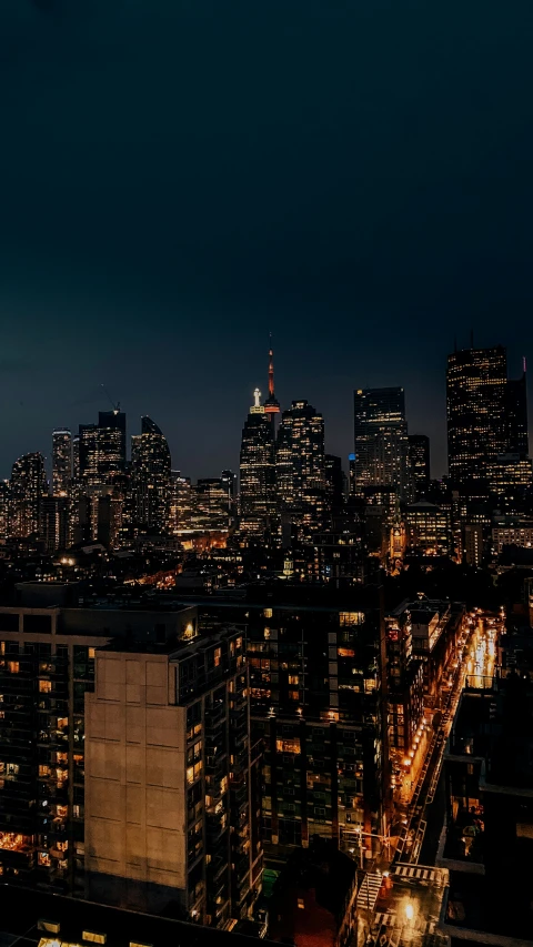 the city lights of new york are lit up against the dark night