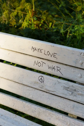 a wooden bench with writing on it