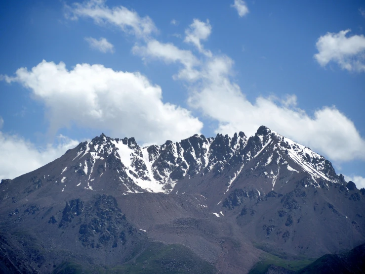 snow - covered mountains stand tall on a clear day