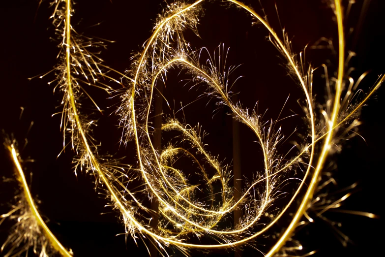 some very pretty yellow fireworks on a black background