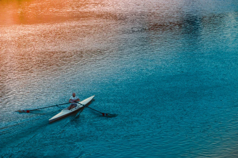 an aerial view of a kayak on the water