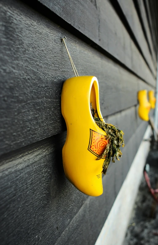 a yellow toy hanging from the side of a wall