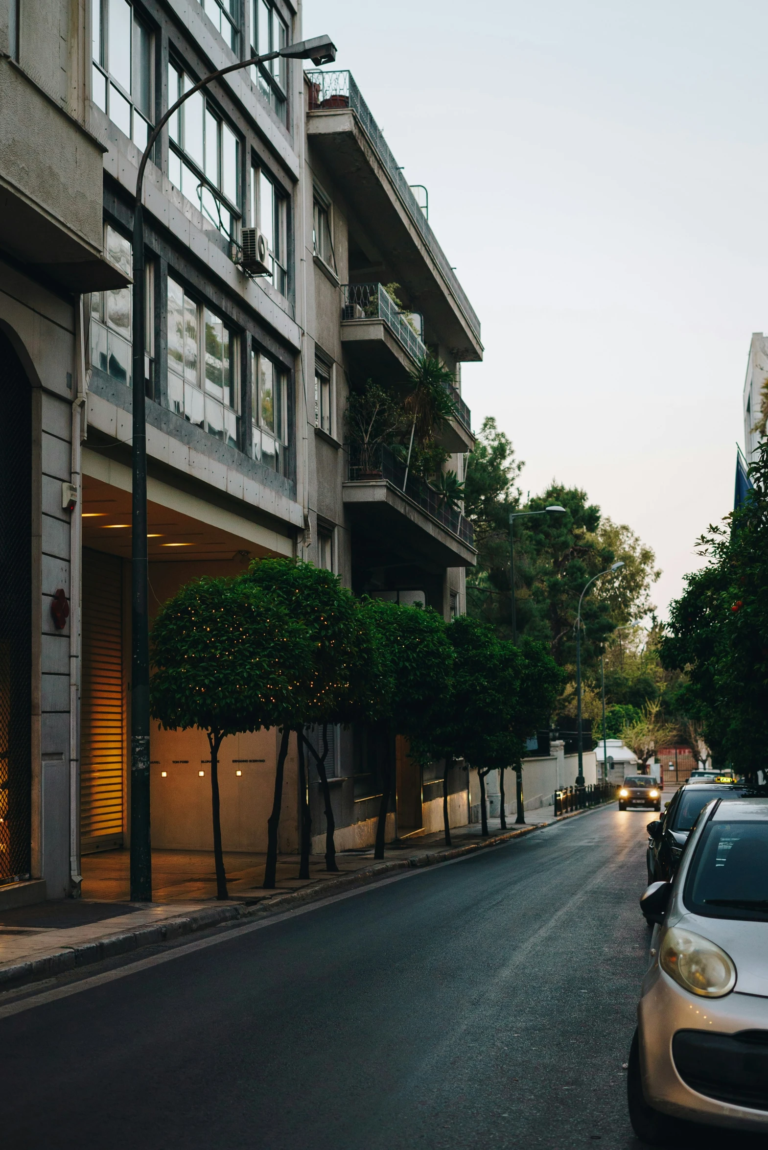 a city street with cars parked in front of buildings