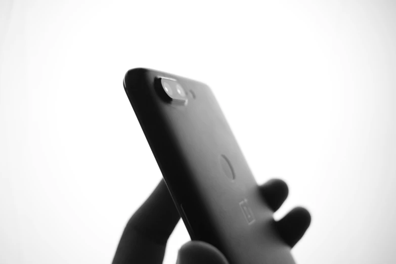 black and white pograph of hand holding an iphone