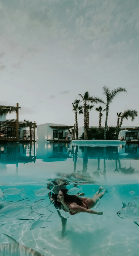 a person swimming in the middle of a swimming pool