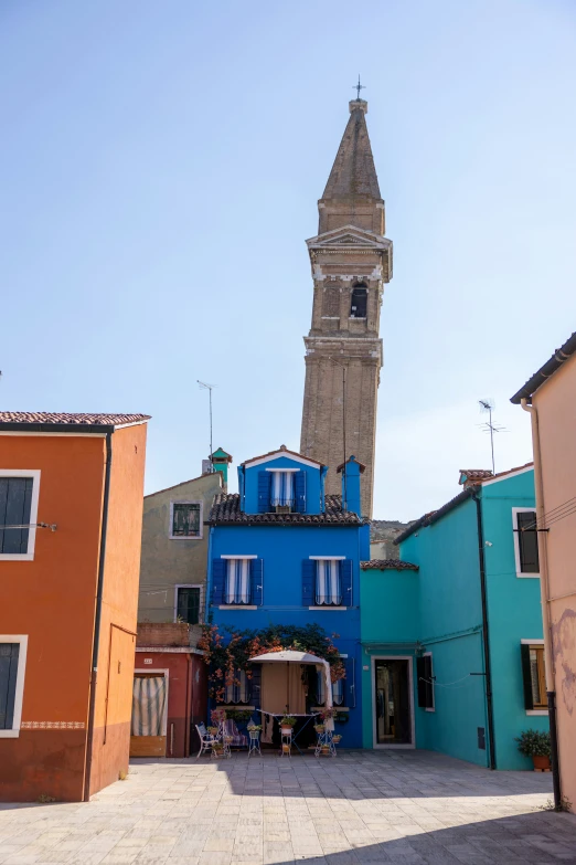 a blue building with a tower and a clock at the top