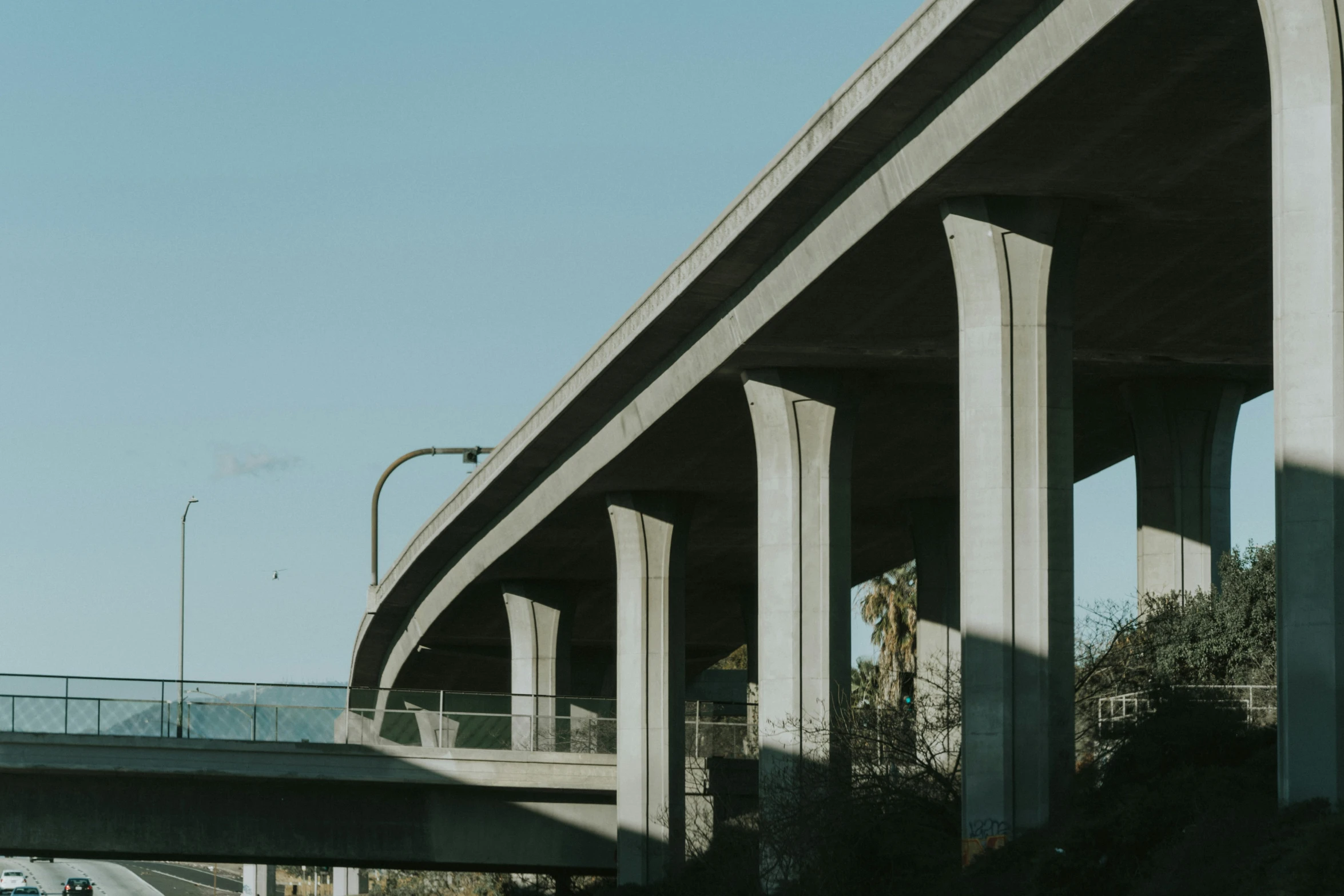 the view of a road with very tall concrete pillars