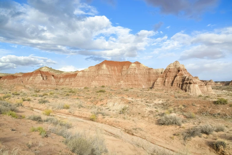 a big sandy hill next to some rocky mountains