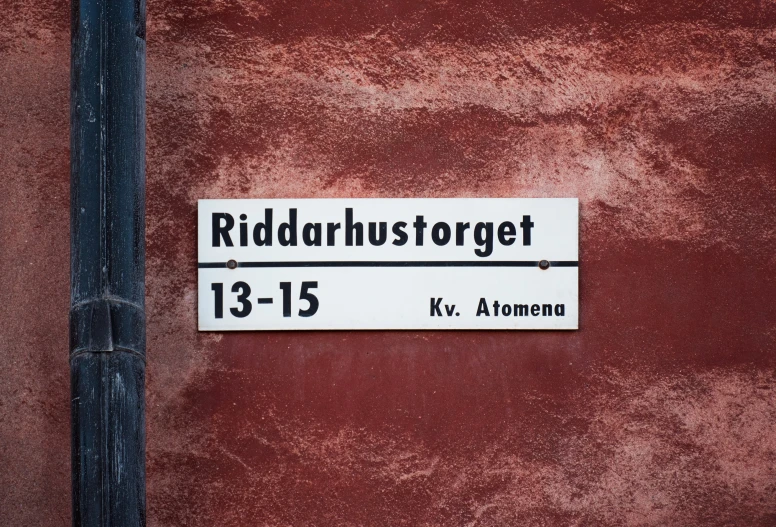 a red brick building with a white sign that reads riddahustorget