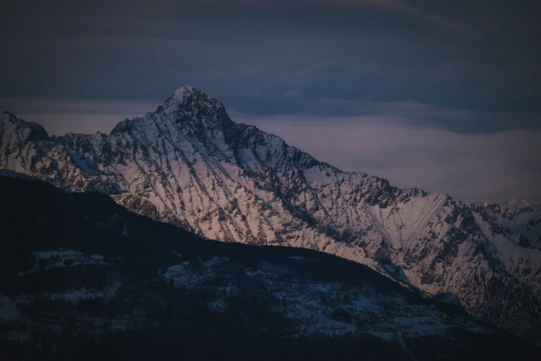 a snowy mountain is seen from the top