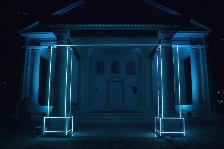 an entrance with two pillars with lighted columns