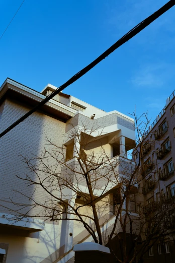 a white building sitting next to trees and buildings