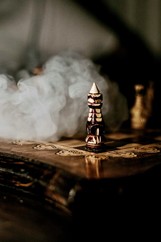 a tower standing in smoke on top of a table