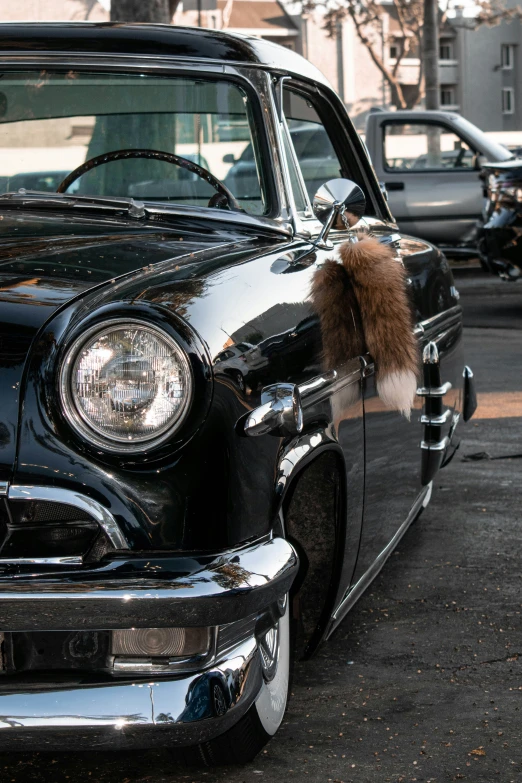 an antique car sits on the street with old timey decorations