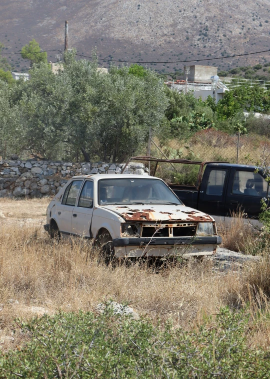 an old car in the middle of nowhere