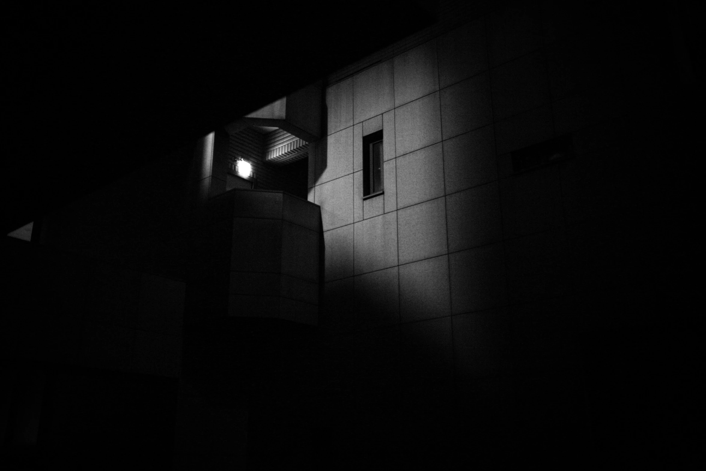 a black and white po of a building with a light on