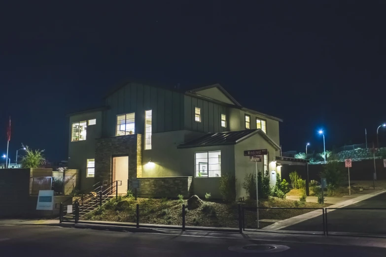 the house is lit up at night outside