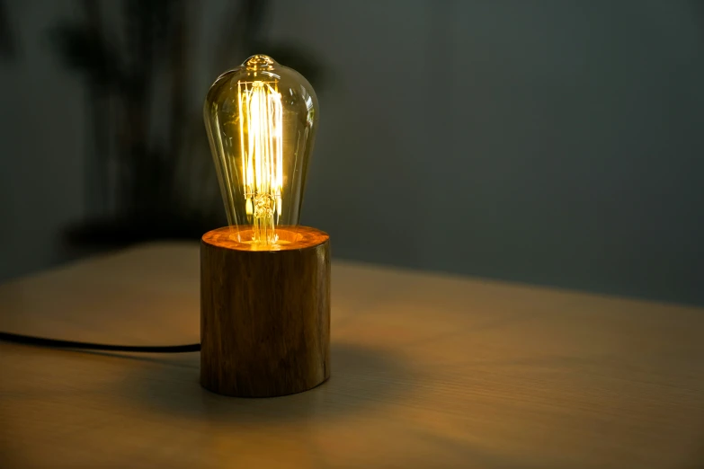 a small wooden table with a light bulb