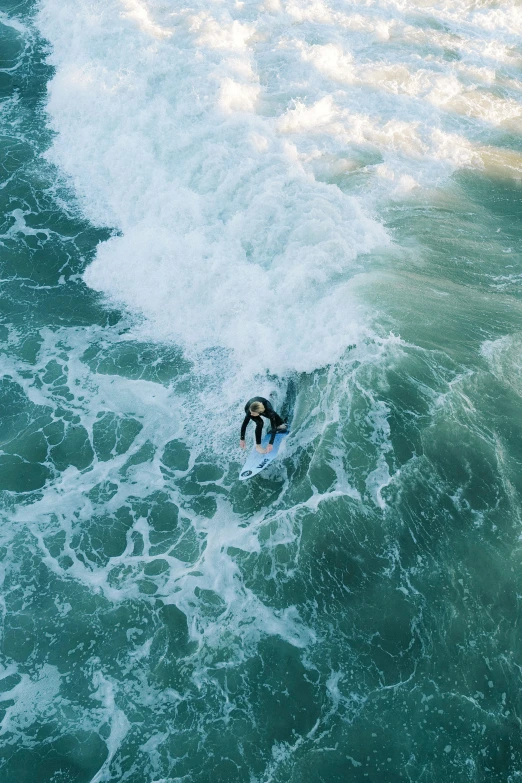 person riding on water with waves in the background