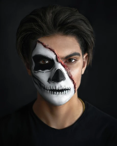 a man with a skull make up painted on his face