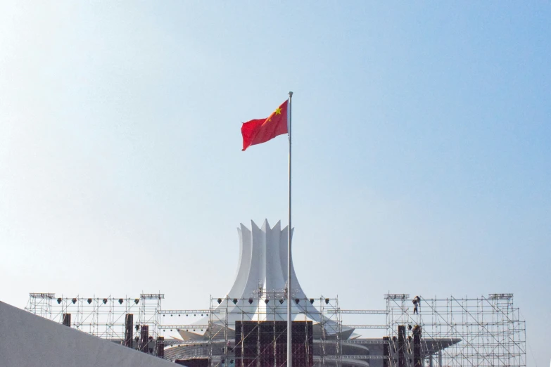 a giant flag flies over an outside concert venue