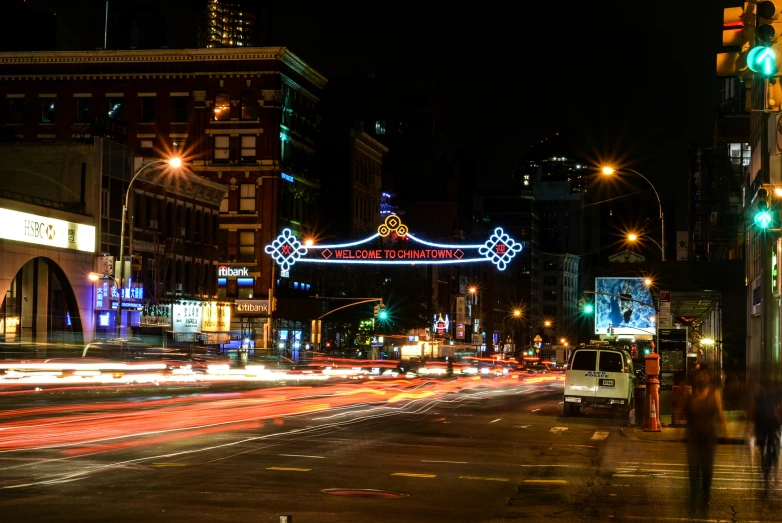 cars driving down a busy street near a traffic signal