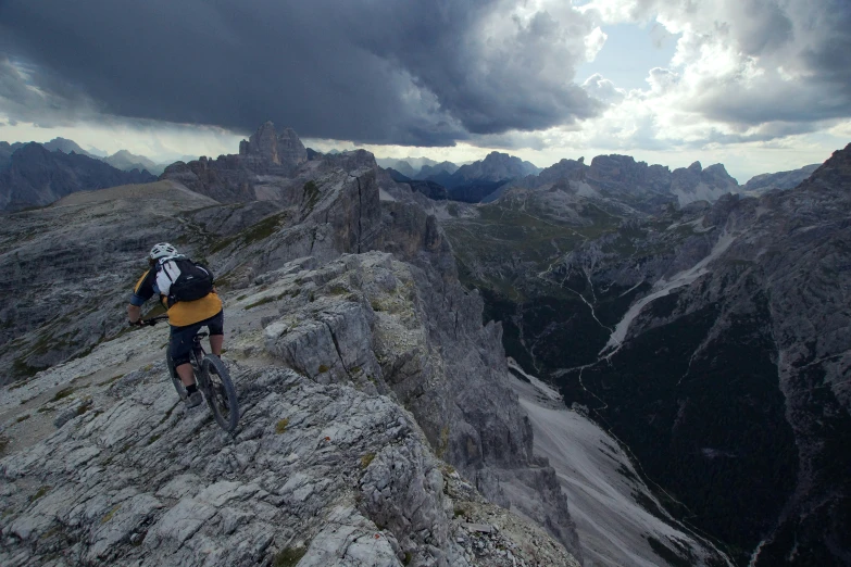 mountain biker with a backpack on top of a mountain