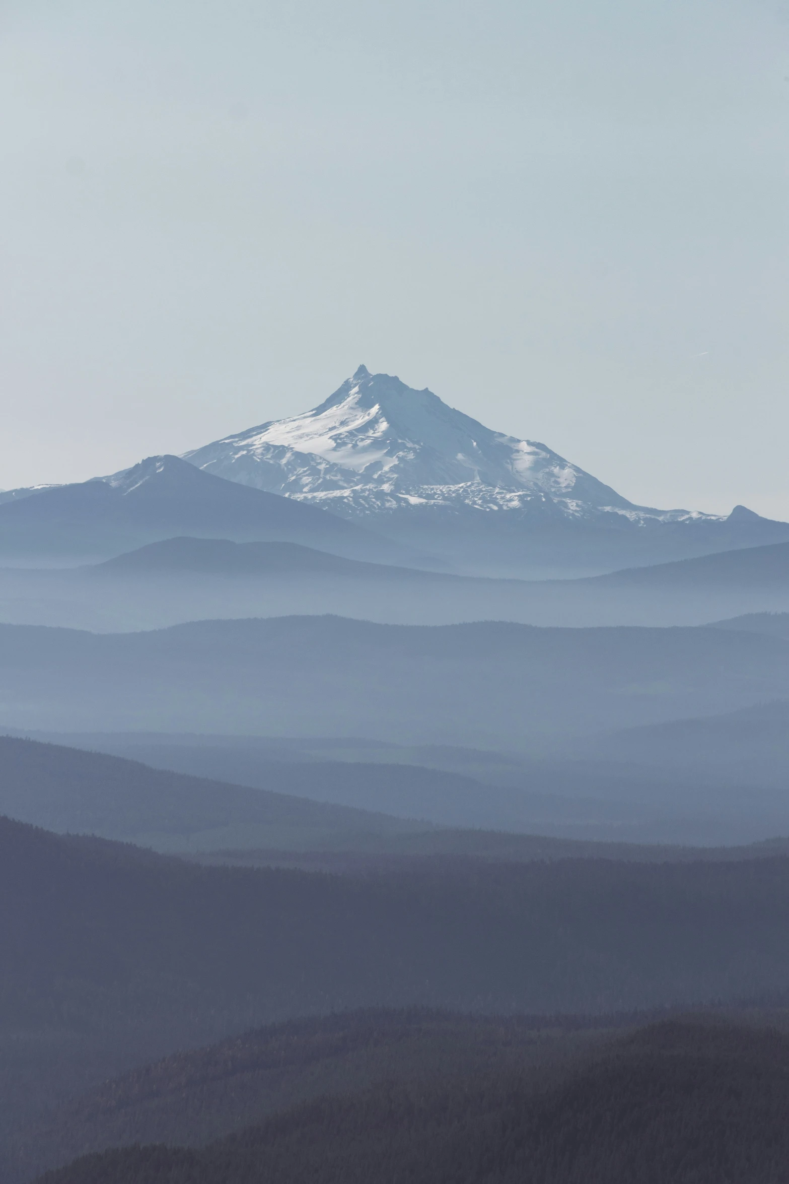 the clouds are rolling by and look like mountain tops