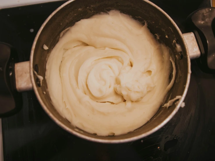 a mixing bowl with a white substance in it