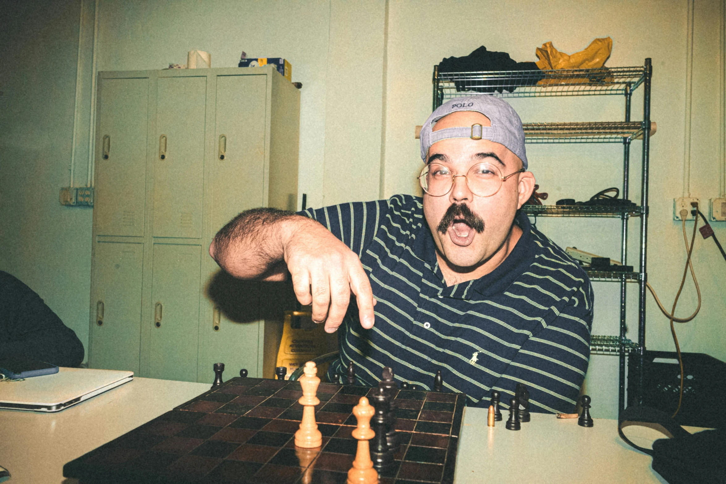 a man with a weird look playing chess