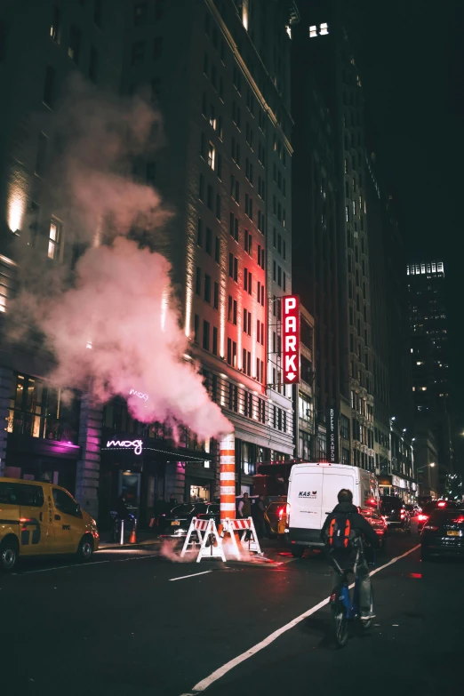 smoke is burning on a busy street at night