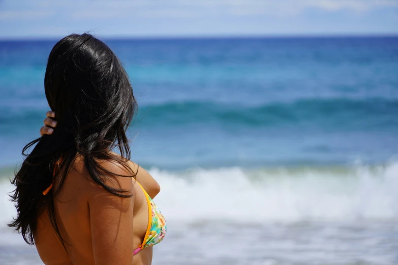 there is a woman that is standing on the beach